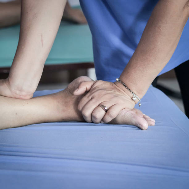 istock senior lady having body and legs massage by therapist. 1095818210