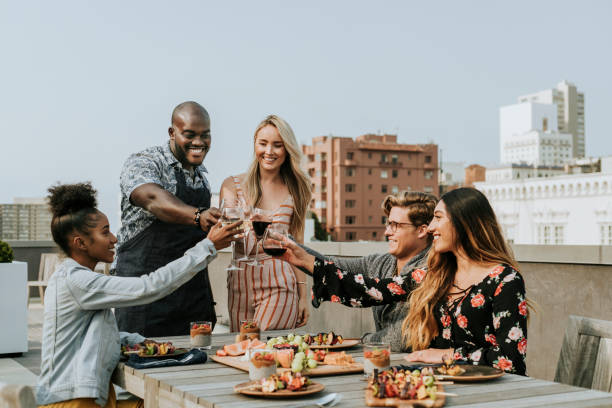 istock Cheerful friends toasting at a rooftop party 1095826700