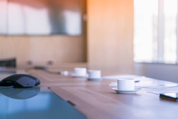 istock Coffee cups on conference table at board room 1095828710