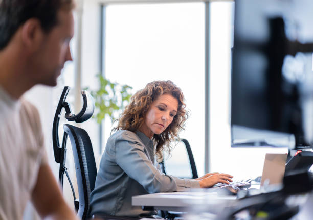 istock Business colleagues working on computer at desk 1095829104