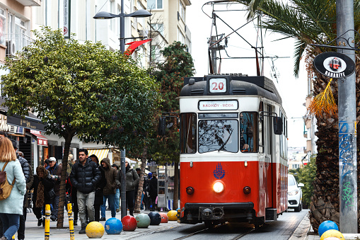 Istanbul, Turkey - January 13, 2018: One of the things that makes Kadıköy, Kadıköy is undoubtedly the nostalgic tram. As pleasant as it is to walk to Moda,  you could shorten that route with this tram. Hop in the tram in warm weather and take a little neighborhood trip from Bahariye to Moda.\nRed Tram in Bahariye Street, Nostalgic Moda Tramway, Kadikoy, Istanbul
