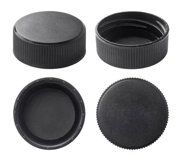 Black plastic bottle caps isolated on white background