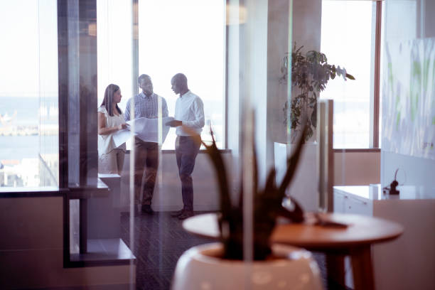 istock Business people discussing over blueprint in office 1095833542