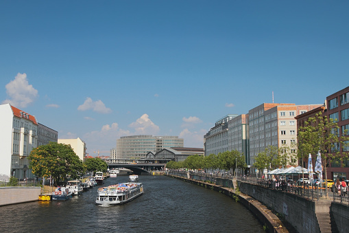 River, cruise motor ships and city. Berlin, Germany