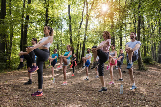 istock Group of athletic people doing stretching exercises in the forest. 1095839462