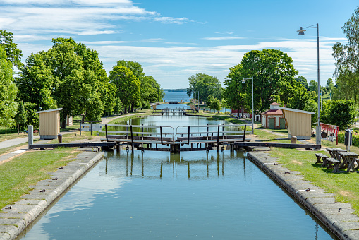 Berg, Sweden, 06-06-2018\nBeautiful summer view of the famous sea lock stair at Berg along the Gota canal in Sweden. In bright sunshine with green trees and blue and cloudy sky