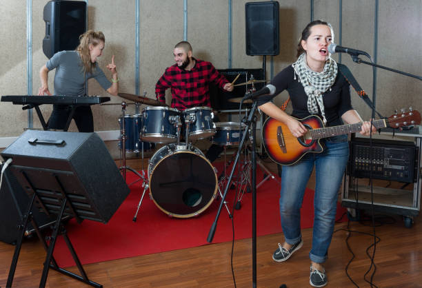 istock Expressive guitar player and singer with band 1095862810