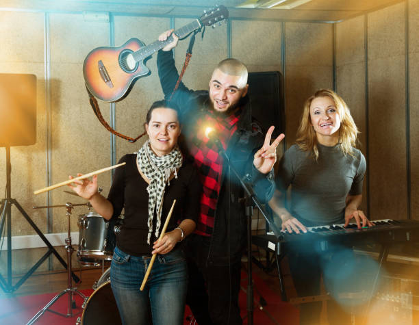 istock expressive group of rock musicians posing with instruments 1095862842