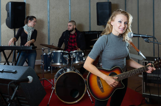 istock Great guitar player and singer with band 1095862848