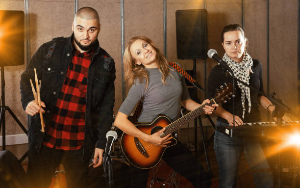 istock group of rock musicians posing with instruments 1095862890