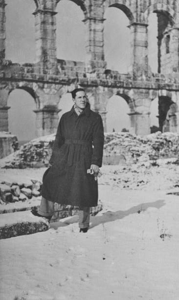 istock Young man visiting Colosseum in Rome in 1939 1095865046