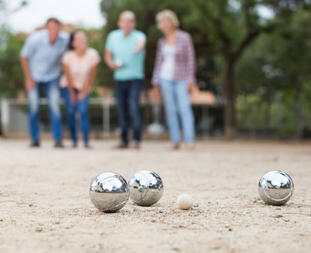 istock friendly mature couples playing petanque at leisure 1095866112