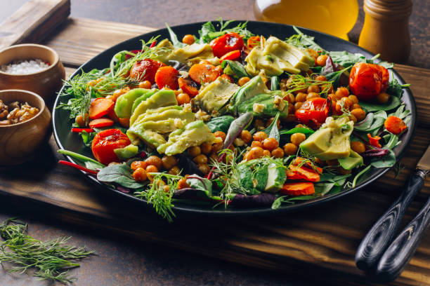 istock Avocado, roasted tomato, greens and chickpeas salad 1095867834