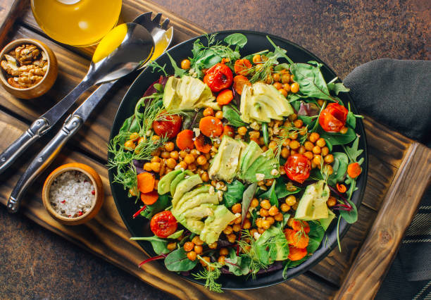 istock Avocado, roasted tomato, greens and chickpeas salad 1095867836