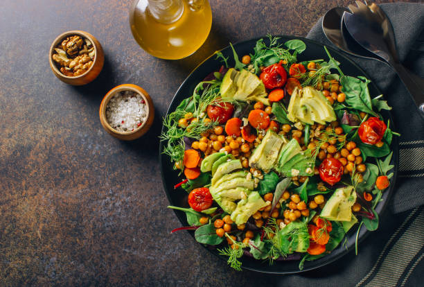 istock Avocado, roasted tomato, greens and chickpeas salad 1095867844