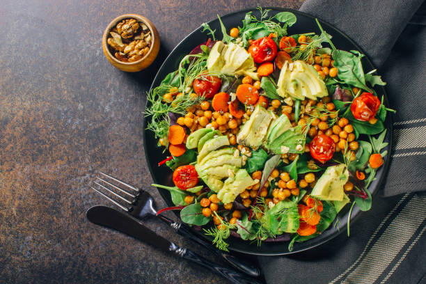 istock Avocado, roasted tomato, greens and chickpeas salad 1095867850