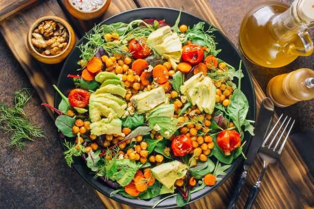 istock Avocado, roasted tomato, greens and chickpeas salad 1095867852