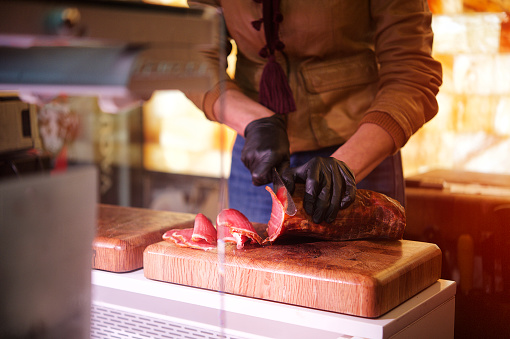 Careful cutting of meat jamon smoked ham fillets preparation Valencia Spain