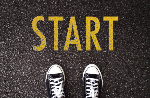 istock Black shoes standing at the road with start wording. 1095874722