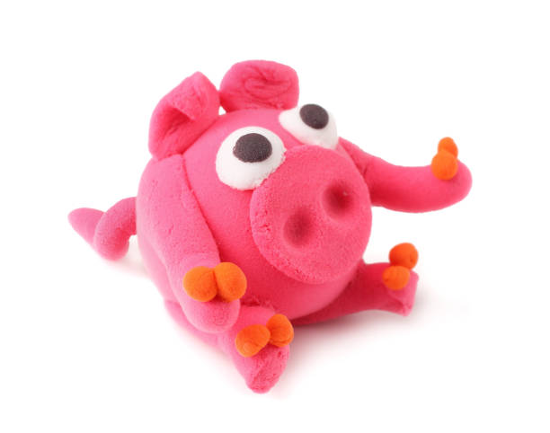 istock Kids modelling clay pig isolated on white background 1095876524