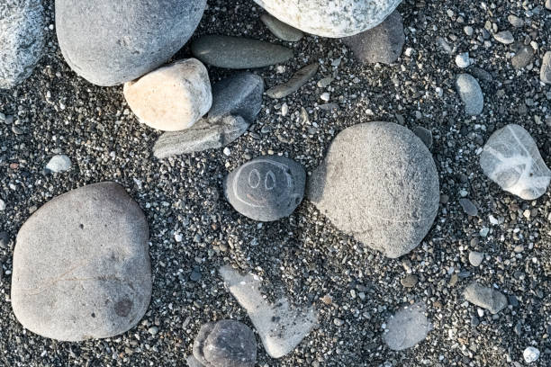 istock Painted smiley on a pebble stone on a beach on a Sunny day 1095878178