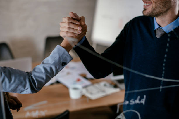 istock Business people drawing graph on glass wall 1095881068
