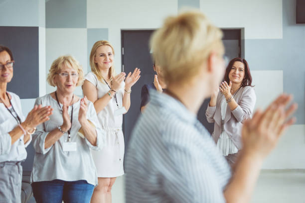 istock Group of women clapping hands during seminar 1095883692