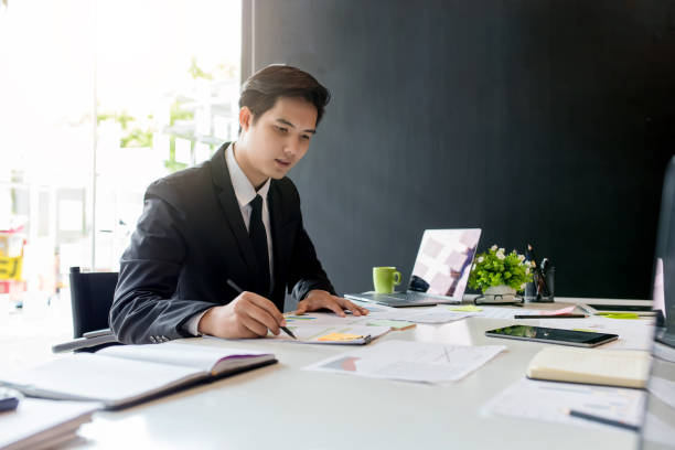 Businessman sitting analyze document information in the workplace.