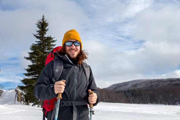 istock Man hiking in snow mountains 1095885388