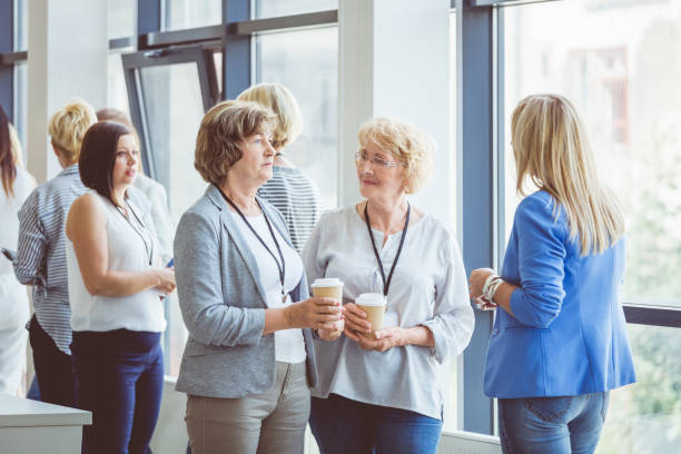 istock Women talking during a break in seminar 1095887356
