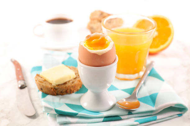 istock breakfast with boiled egg, coffee and orange juice 1095888260