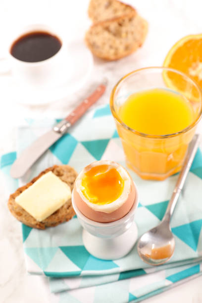 istock breakfast with boiled egg, coffee and orange juice 1095888276