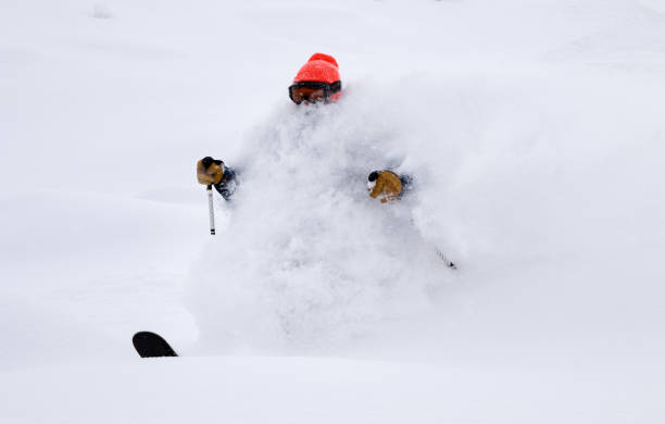 narciarz z powrotem country z czerwonym kapeluszem jeżdżącym w głębokim śniegu w proszku - skiing winter sport powder snow athlete zdjęcia i obrazy z banku zdjęć