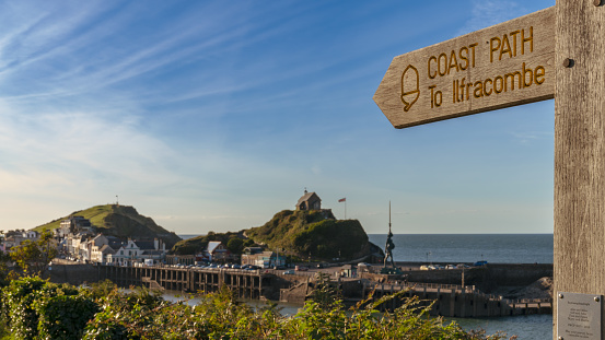 Sign: Coast Path to Ilfracombe, with Ilfracombe in North Devon, England, UK in the background