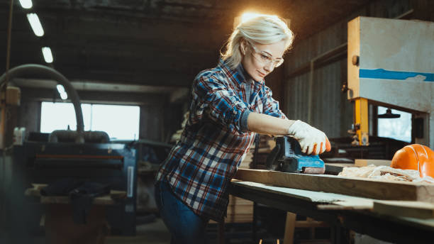 istock Active middle aged woman selects wood in workshop. Concept of professionally oriented motivated modern woman. Gender equality, image of femininity 1095898766