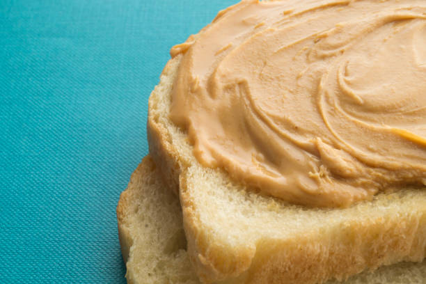 istock Peanut butter sandwich half cut isolated with blue background 1095902198
