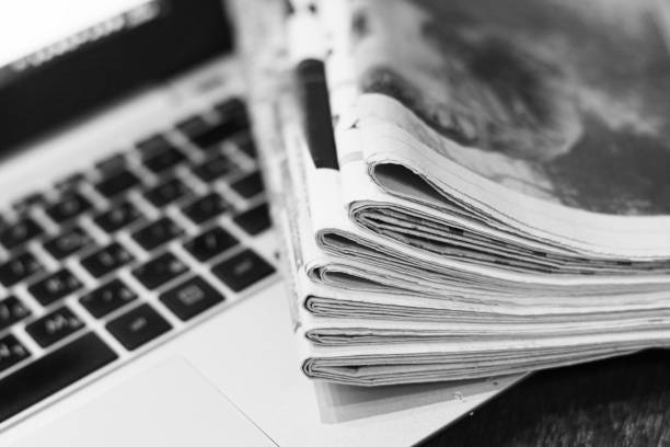 istock Newspapers and Laptop 1095905262