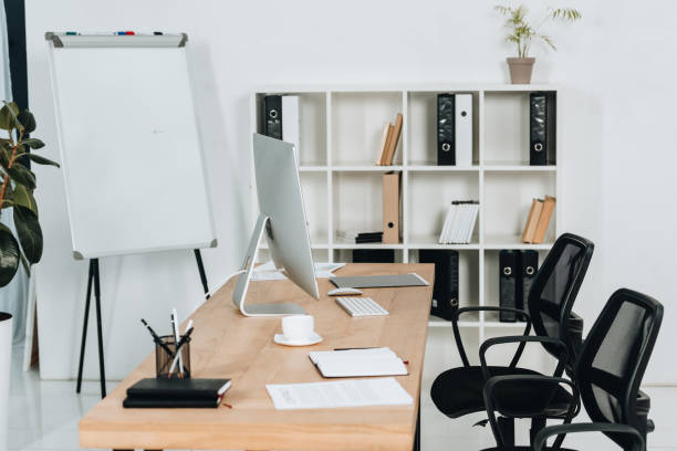 istock modern office interior with desktop computer and office supplies, chairs and whiteboard 1095911044