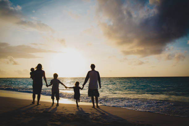 istock happy family with tree kids walk at sunset beach 1095914804