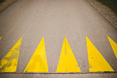 Yellow bump sign on asphalt