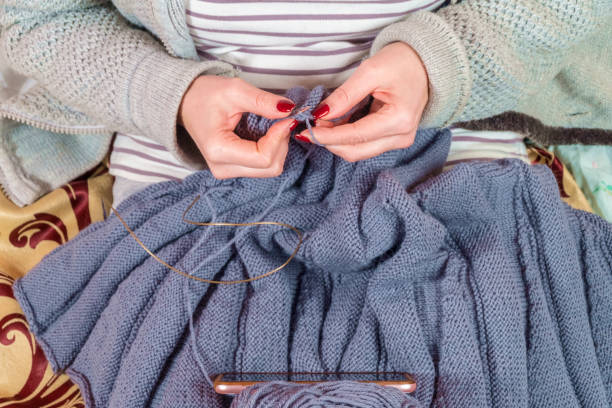 istock woman knits with a smartphone 1095925588