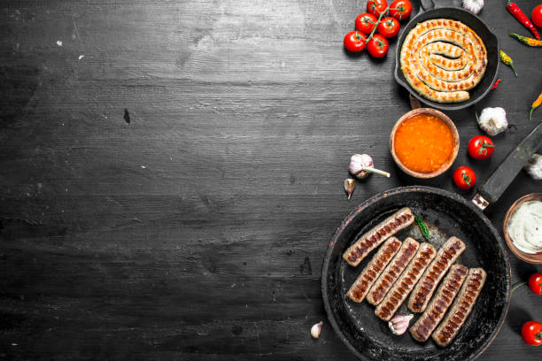 istock Fried sausages with garlic, herbs and hot chili peppers. 1095925680