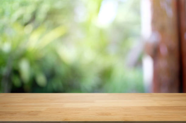 istock empty wood table with blurred montage nature green place background 1095927872