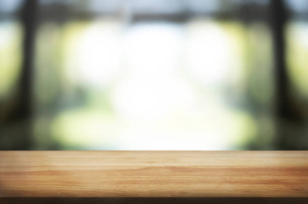 istock empty wood table over blurred outdoor cafe background 1095927892