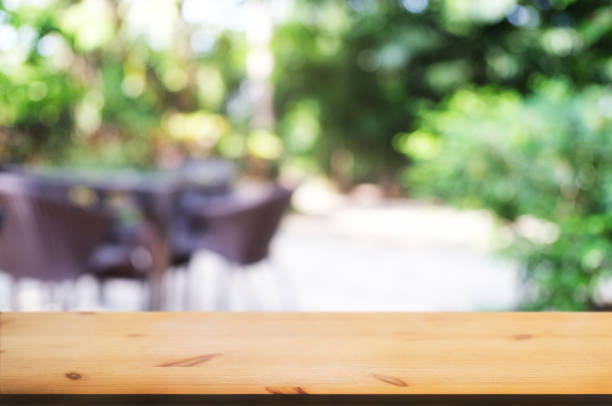 istock empty wood table with blurred montage nature green place background 1095927916
