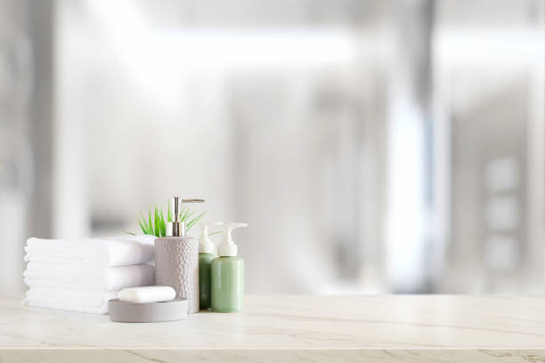istock Ceramic shampoo, soap bottle and towels on counter over bathroom background. table top and copy space 1095928712
