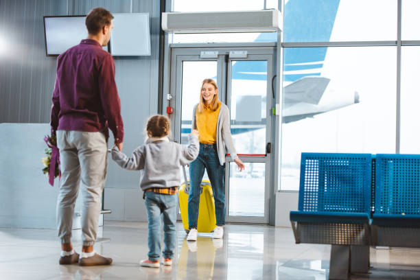 istock selective focus of mother with baggage looking at husband and daughter holding hands while meeting in airport 1095928796