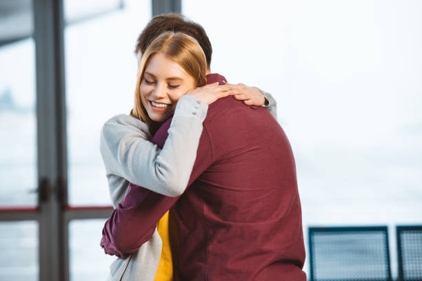 istock attractive woman smiling with closed eyes while hugging boyfriend 1095928808