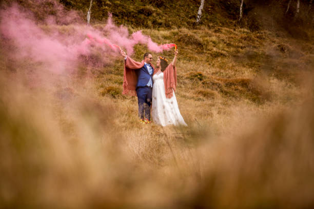 istock Beautiful wedding couple posing with smoke-producing in hands 1095933868