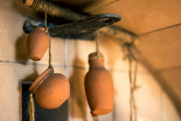 istock Ceramic jugs on a hanging rope on a white wall background 1095936200